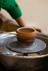 18. Wet clay cup forming under artisan hands 