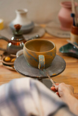 11. Clay cup forming on pottery wheel 