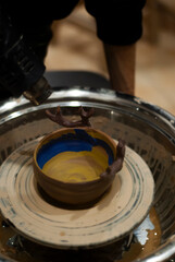 Clay vessel taking shape on wheel