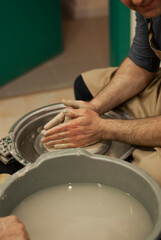 Sculpting raw clay with fingers