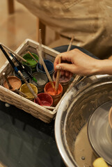 Artist hand-painting clay sculpture 