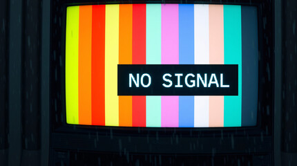 a vintage television screen displaying colorful stripes and a "no signal" message.