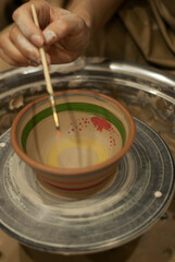 Hand-painted ceramic bowl with brush 