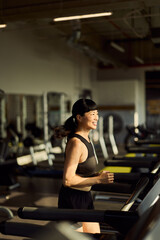 Active Woman Running on a Treadmill in a Modern Fitness Center