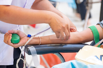 Healthcare professional assisting a donor during blood donation. Symbol of compassion, medical...