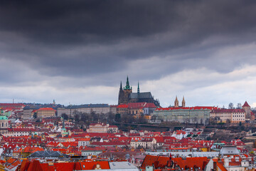 A panoramic view of Prague Castle, captured from the Old Town Hall Tower, showcases red-roofed...