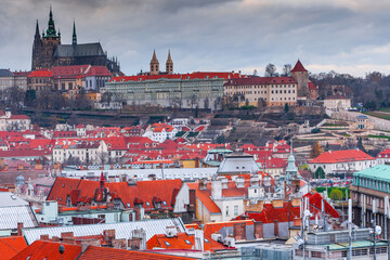 A panoramic view of Prague Castle, captured from the Old Town Hall Tower, showcases red-roofed...