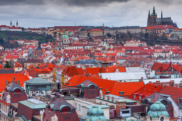 A panoramic view of Prague Castle, captured from the Old Town Hall Tower, showcases red-roofed...