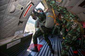Paratroopers Ready for Jump ,Soldiers preparing to jump from a military aircraft, capturing the...
