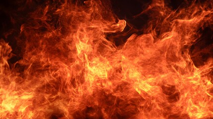 Close-up view of intense flames with a dark background. The image displays the chaotic and dynamic nature of fire. Vivid colors and patterns create a striking visual effect.