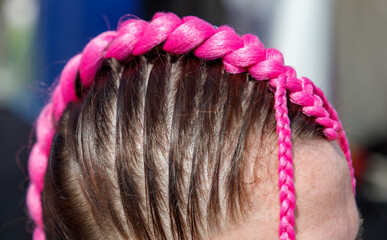A woman with pink hair and a pink headband