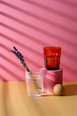 Still life photography with glasses lavender and geometric shapes on pink and orange backdrop