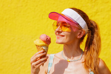 Happy Woman Enjoying Ice Cream Cone on Hot Summer Day with Bright Yellow Background