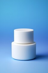 White cosmetic jar mockup on blue background for beauty product packaging presentation shot
