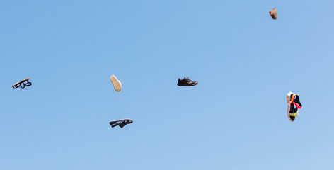 A bunch of shoes are flying in the air