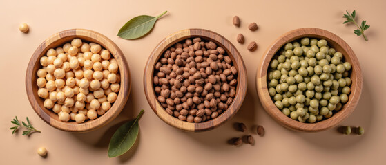 Fototapeta premium Natural ingredients in wooden bowls, showcasing variety of legumes including chickpeas, lentils, and green peas. Perfect for healthy cooking