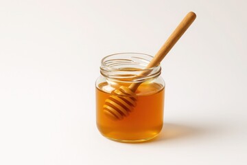 Glass jar of honey with wooden dipper on white background - ideal for natural product branding, health food visuals, and organic marketing concepts.