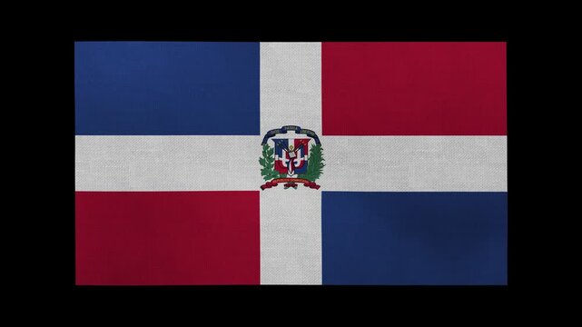 A Dominican Republic flag rolls and waves in front of a black background.