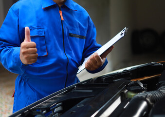 Technicians hold documents detailing maintenance history or technical data for customer service checklists to prepare repair reports for customers.