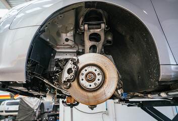 Exposed wheel housing and brake components during vehicle inspection