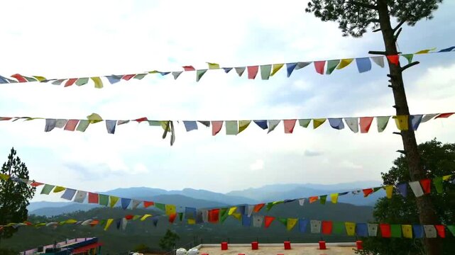 Video of Om Mani Padme Hum flags, also known as Tibetan prayer flags with the sky and clouds in the background.