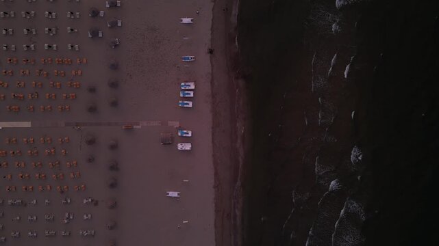 Coastal Landscape: An aerial perspective captures a coastal scene, where the natural textures of the shoreline meet the man-made arrangement of a car park, Rimini, Emilia-Romagna
