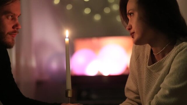 couple in the evening by candlelight on a date romantically communicate