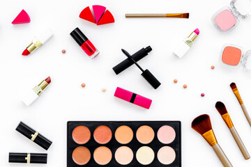 Flatlay of makeup cosmetics on white background. Blusher, mascara and lipstick, top view