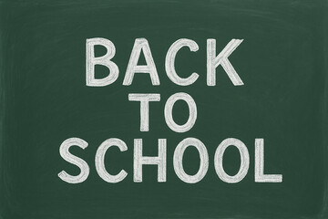 Back to school written in chalk on green schoolboard.