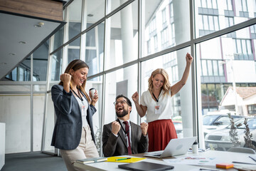 Business team celebrating success in modern office