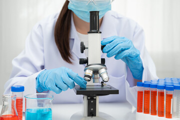 Scientist medical professional use microscope for research in science laboratory.