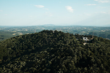 Scenic mountain landscape with dense forest and hilltop buildings, viewed from Avala Tower near...