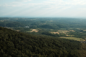 Wide view of lush forested hills and farmland near Belgrade, Serbia, taken from Avala Tower on a clear day.
