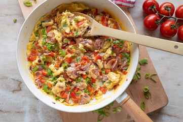 Scrambled eggs with ham and vegetables. Healthy quick breakfast, dinner or luch fresh and homemade cooked