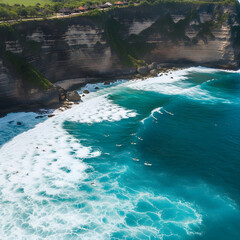 An aerial view of surfers in the vibrant turquoise ocean next to a dramatic, lush green cliffside.