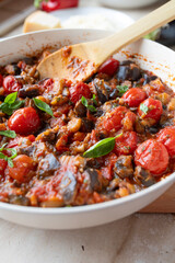 Eggplant, tomato ratatouille in a skillet fresh and homemade cooked. Healthy summer food