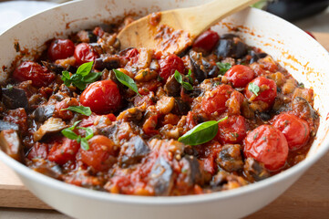 Eggplant, tomato ratatouille in a skillet fresh and homemade cooked. Healthy summer food