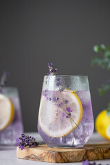Fresh lavender lemonade displayed on a cutting board. Delicate lavender sprigs enhance the drink's visual appeal. Detox and herbal beverage. top view