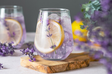 Fresh lavender lemonade displayed on a cutting board. Delicate lavender sprigs enhance the drink's visual appeal. Detox and herbal beverage. top view