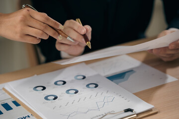 Business people discussing using financial document data charts and graphs. Business meeting. Financial analysis to determine business growth strategy and success.