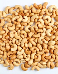 Close-up of cashews, showcasing their unique shape and inviting color ideal for themes of healthy snacks, vegan recipes, or wholesome ingredients. A collection of cashews, ready to be enjoyed 