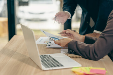 Business people discussing using financial document data charts and graphs. Business meeting. Financial analysis to determine business growth strategy and success.