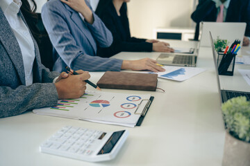 Business people discussing using financial document data charts and graphs. Business meeting. Financial analysis to determine business growth strategy and success.