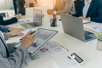 Business people discussing using financial document data charts and graphs. Business meeting. Financial analysis to determine business growth strategy and success.