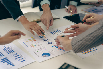 Business people discussing using financial document data charts and graphs. Business meeting. Financial analysis to determine business growth strategy and success.