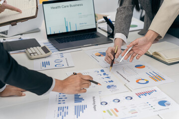 Business people discussing using financial document data charts and graphs. Business meeting. Financial analysis to determine business growth strategy and success.