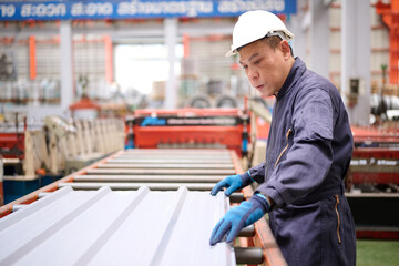 Technician or worker checking metal sheet in the factory