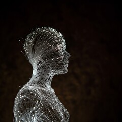 Abstract profile of a head, composed of glowing fiber optic strands, illuminated in the dark. 