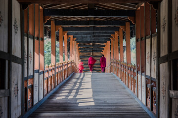 Monks cross a bridge in Bhutan