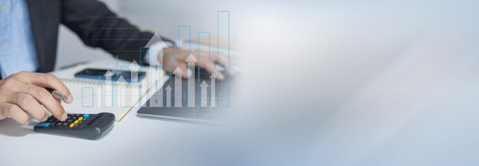 Businessman using laptop for analytics, finance and banking technology.